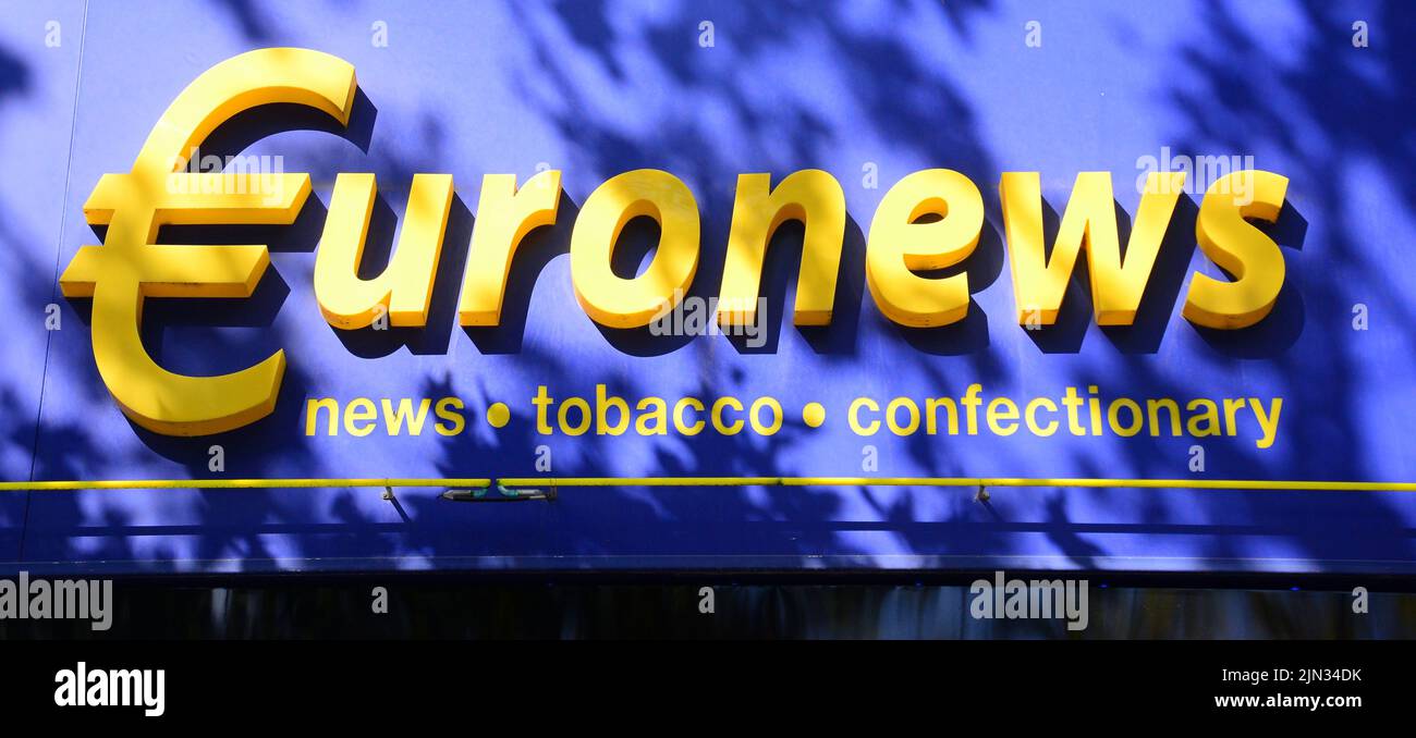 Exterior sign at a Euronews shop or store selling newspapers, tobacco and confectionery Stock Photo