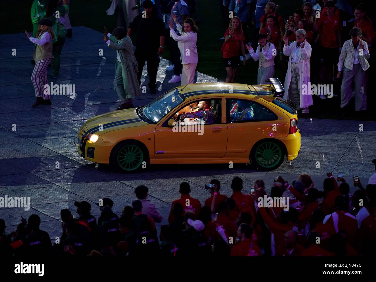 Performers arrive by car to the music of Panjabi MC during the Closing Ceremony for the 2022 Commonwealth Games at the Alexander Stadium in Birmingham. Picture date: Monday August 8, 2022. Stock Photo