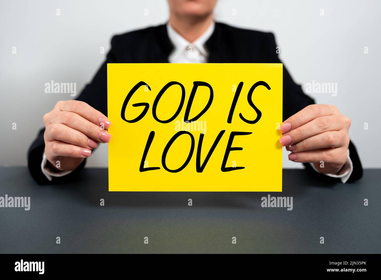 Text showing inspiration God Is Love. Internet Concept Believing in Jesus having faith religious thoughts Christianity Businesswoman Holding Note With Stock Photo
