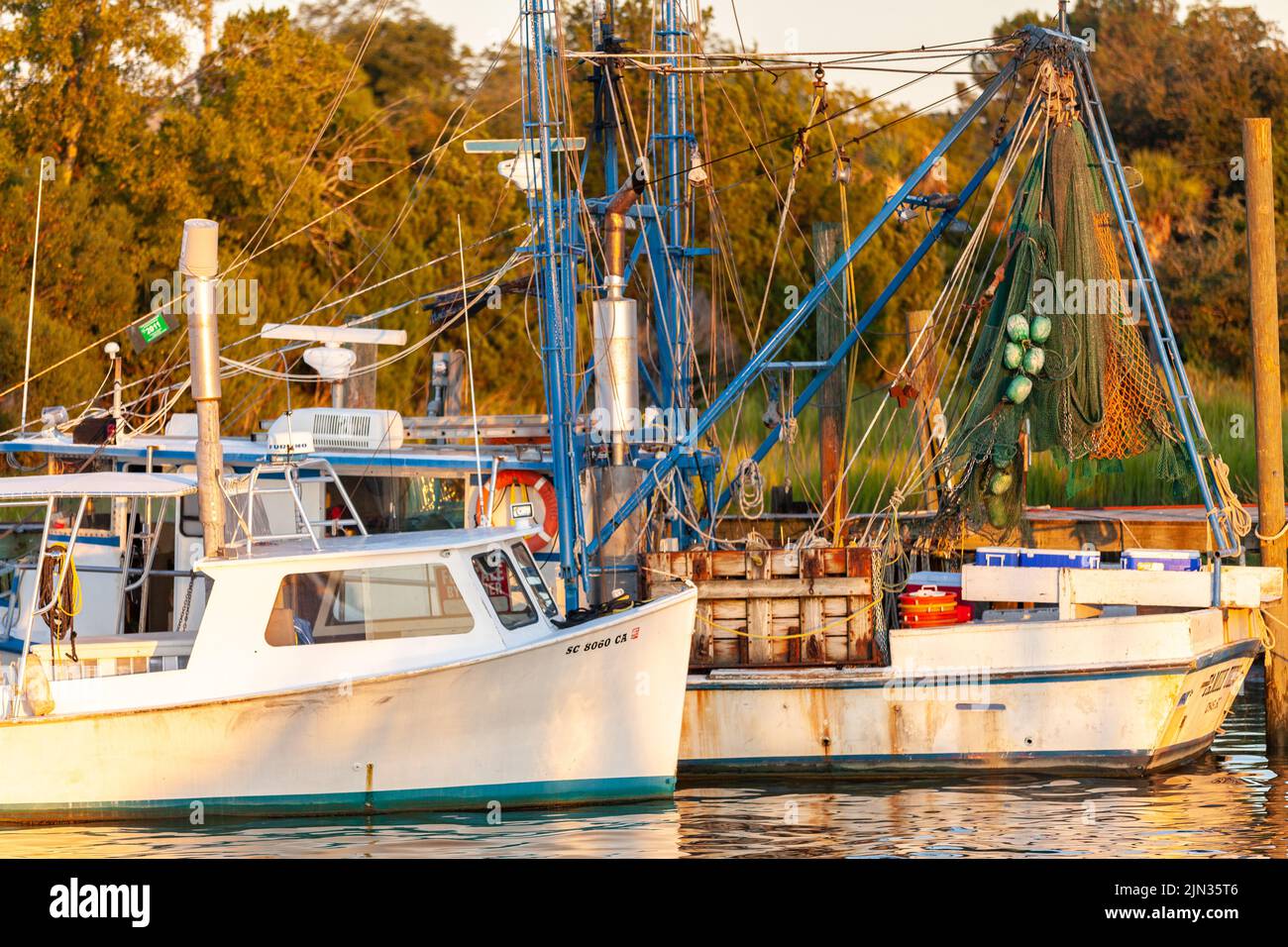 Shrimp boats tied up on Shem Creek at sunrise in Mount Pleasant, South Carolina Stock Photo