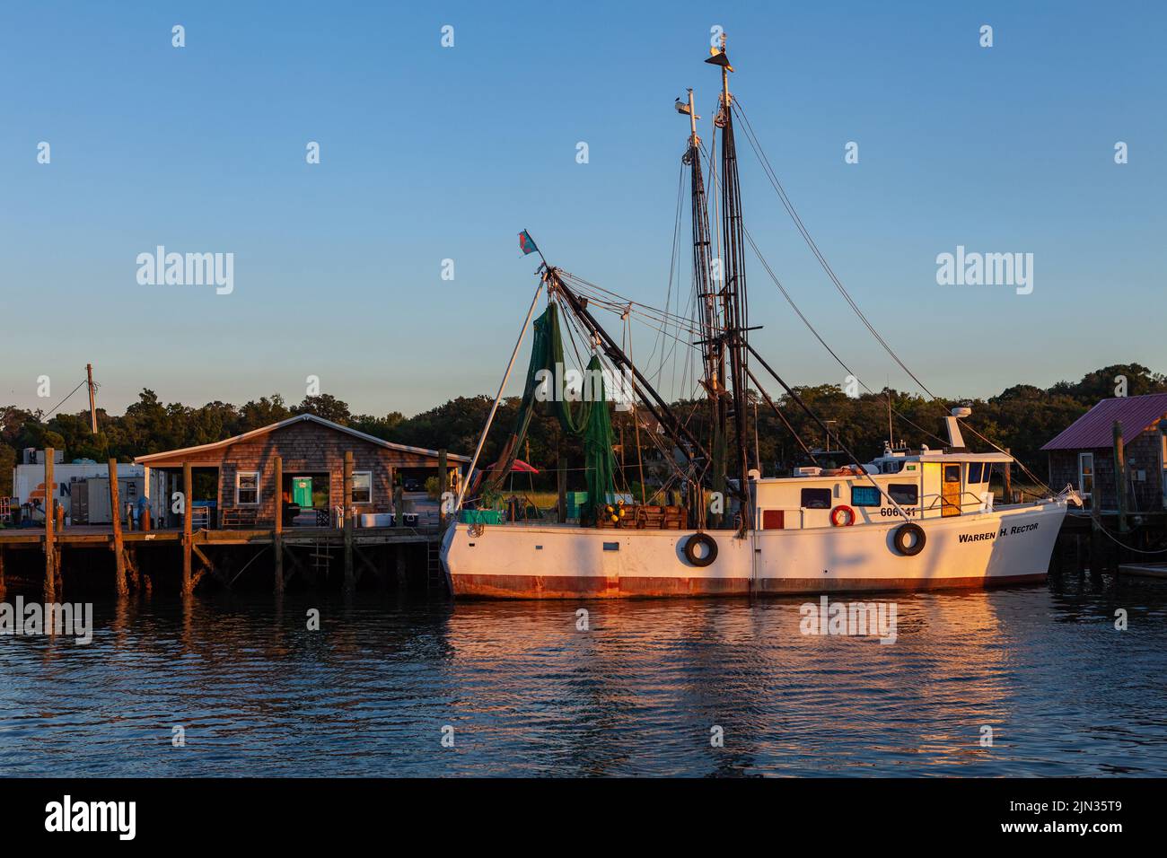 A shrimp boat tied up on Shem Creek at sunrise in Mount Pleasant, South Carolina Stock Photo