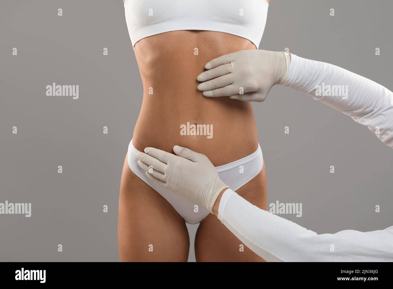 Body Sculpting Concept. Unrecognizable Young Female Getting Consultation At Plastic Surgery Clinic Stock Photo