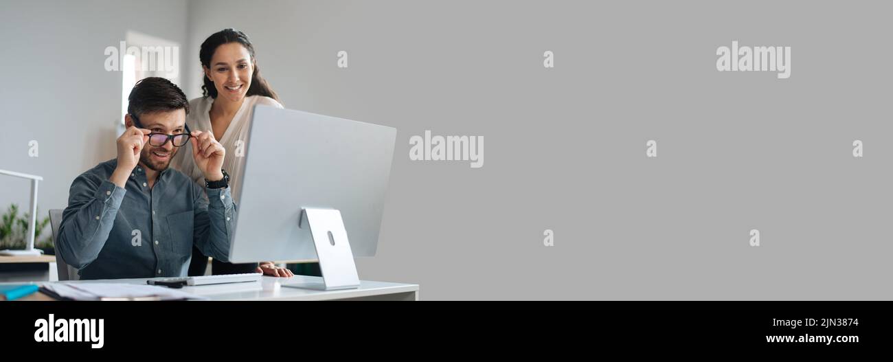 Two happy colleagues working on startup project together, copy space Stock Photo