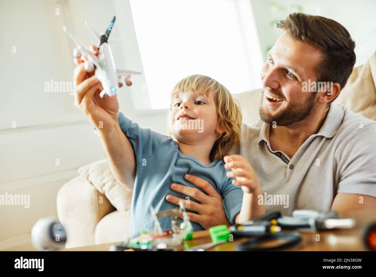 child son father family happy playing kid childhood dad love fun smiling little man home toy airplane travel vacation plane holiday Stock Photo