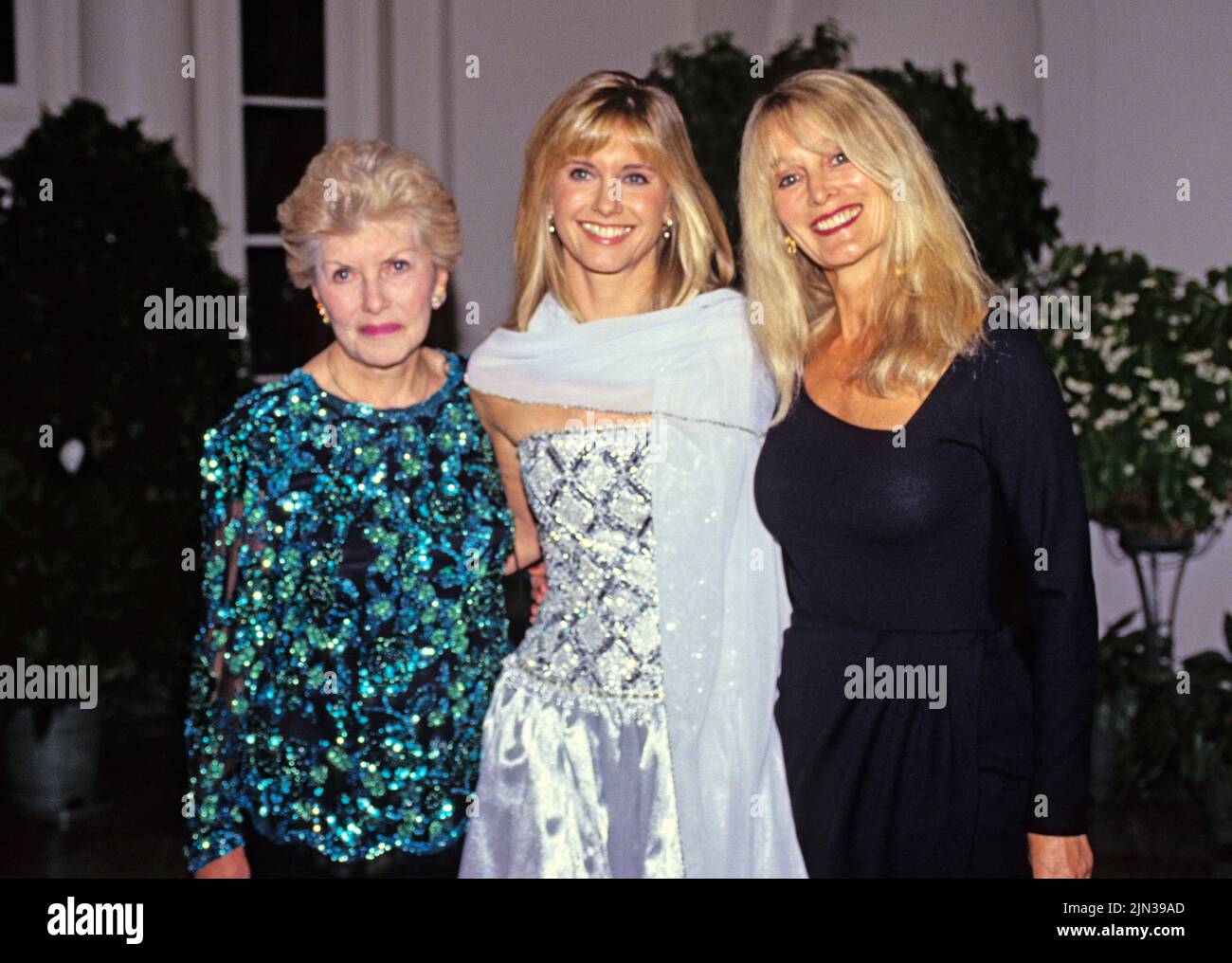 Australian singer, songwriter and actress Olivia Newton-John, center, arrives for the State Dinner hosted by United States President George H.W. Bush and first lady Barbara Bush honoring President Václav Havel of Czechoslovakia at the White House in Washington, DC with her mother, Irene Newton-John, left, and sister, Rona Newton-John, right, on October 22, 1991.Credit: Ron Sachs/CNP/Sipa USA Credit: Sipa USA/Alamy Live News Stock Photo