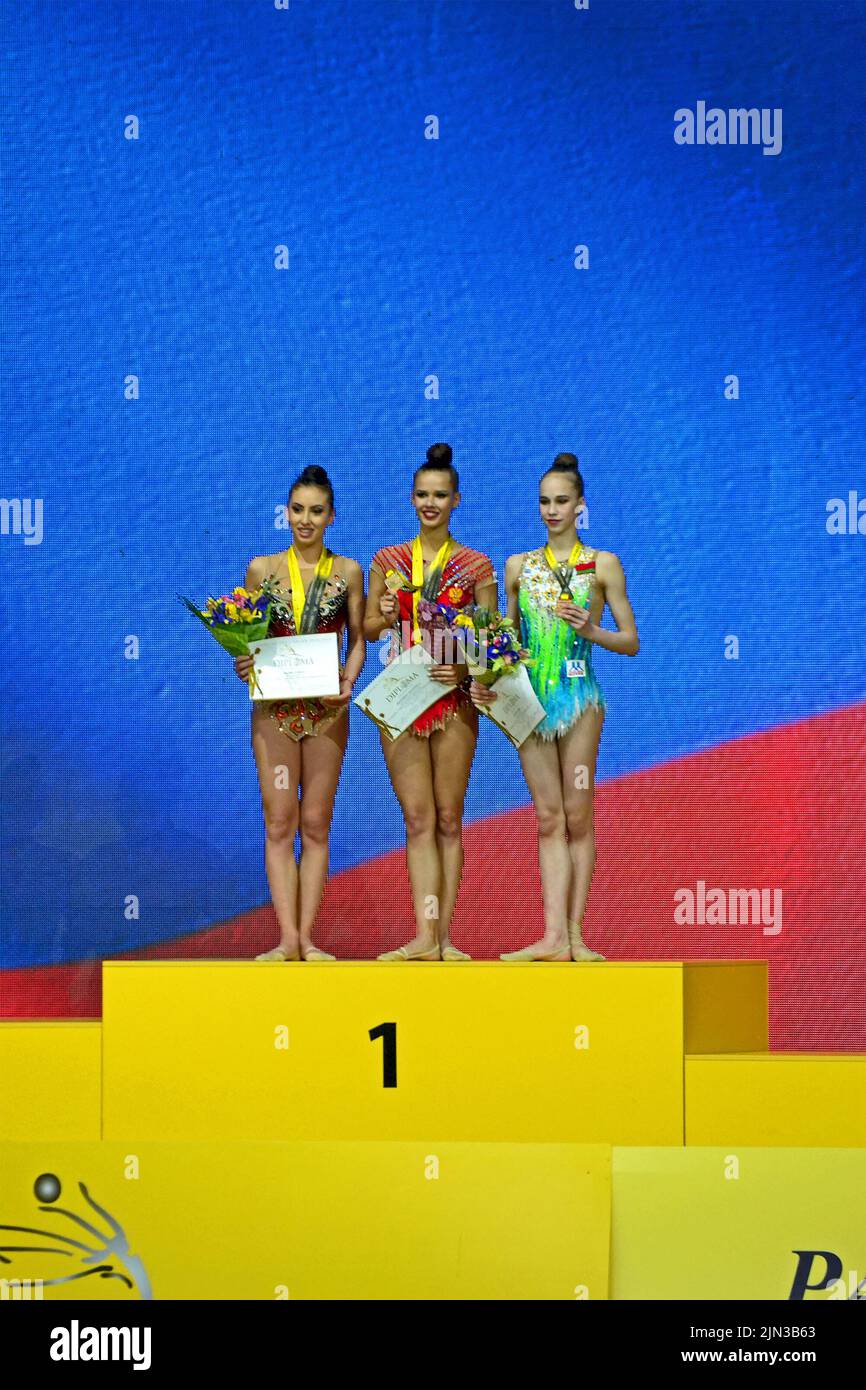 Deriugina Cup Grand Prix 2018 winner celebrations in Kiev, Ukraine. Happy gymnast group on the pedestal with medals. Stock Photo