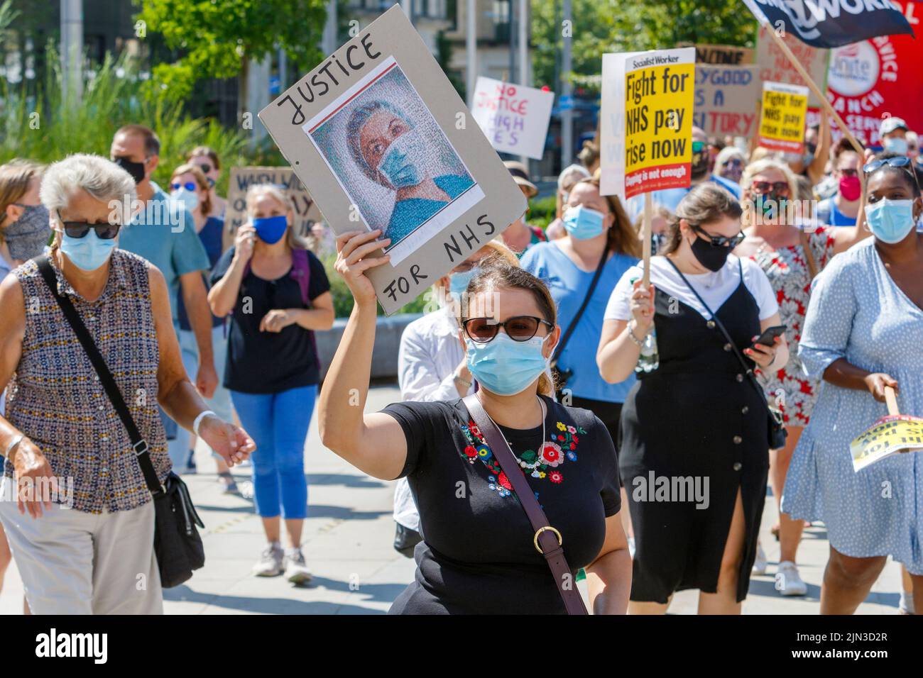 Placard carrying protesters are pictured as they take part in an NHS workers ‘pay justice’ demonstration and protest march in Bristol, 8th August 2020 Stock Photo