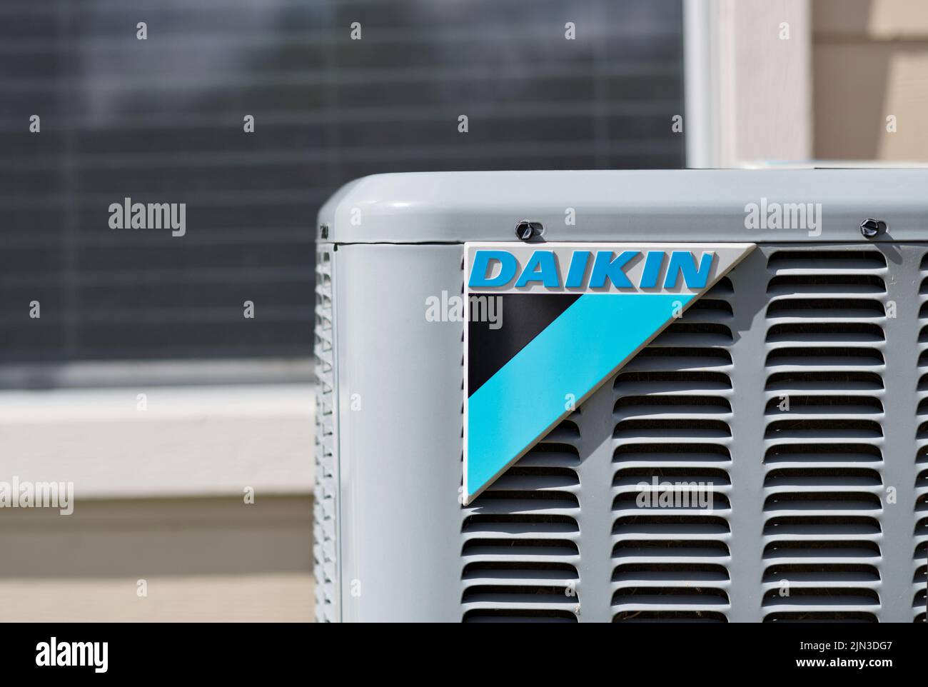 Houston, Texas USA 08-08-2022: Daikin air conditioner unit, corner view at eye level with logo and domestic window in the background. Stock Photo