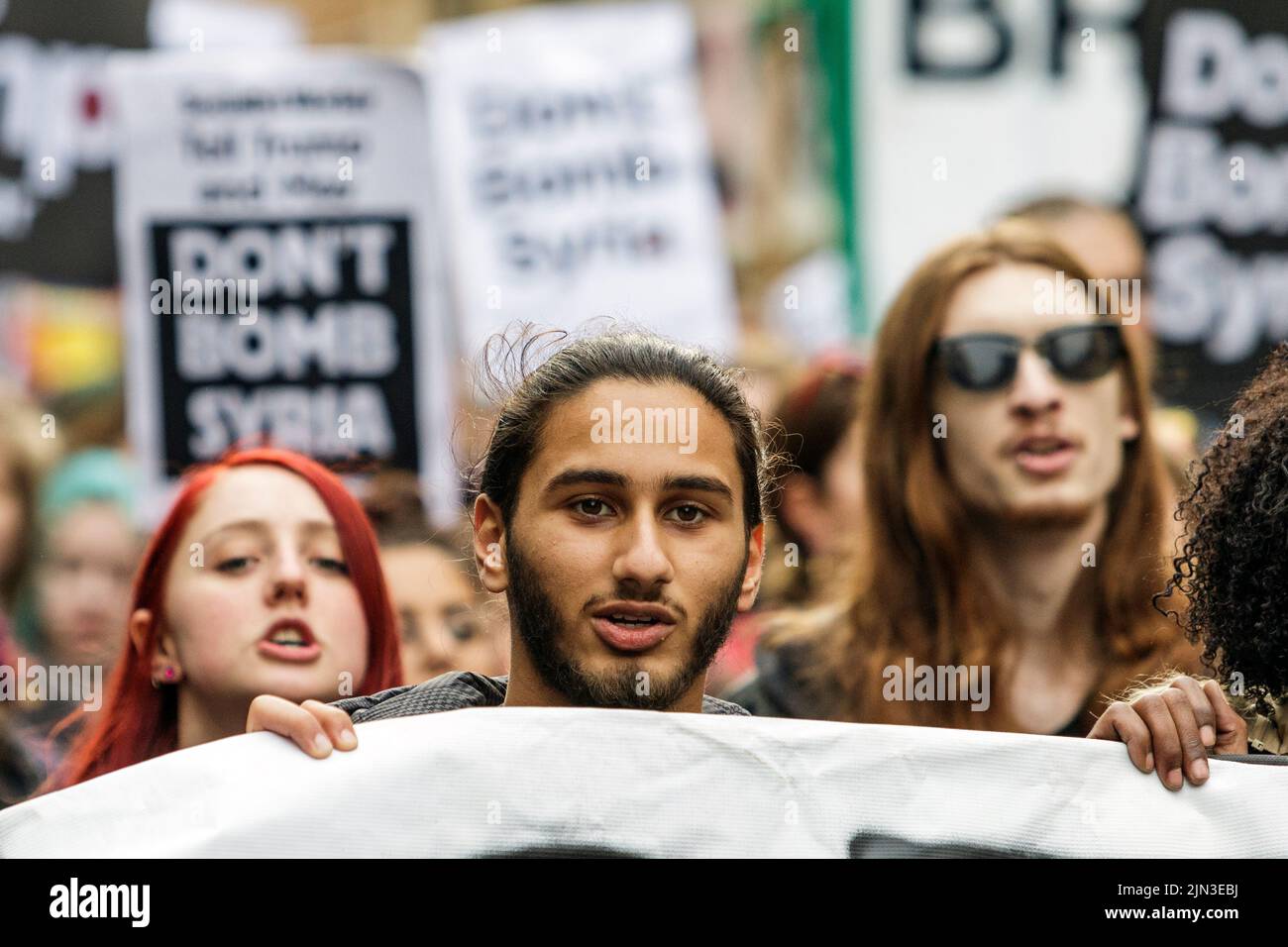 Protesters carrying ‘Don’t bomb Syria’ placards are pictured as they march through Bristol during a Stop Bombing Syria protest march.16th April, 2018 Stock Photo