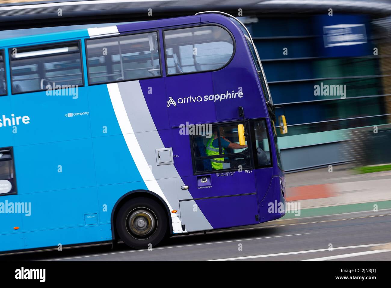 A moving double decker bus operated by Arriva, seen driving through