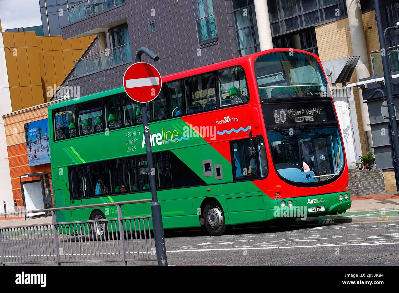 A panning shot of a moving double decker bus in Leeds City Centre  operated by The Keighley Bus Company. Stock Photo