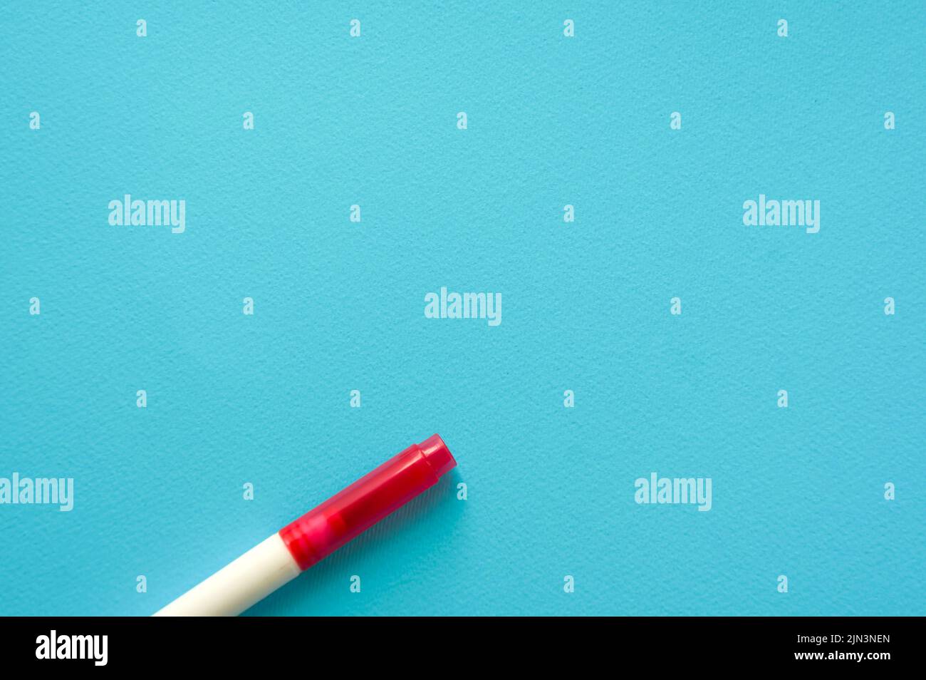 The creative concept of creativity is empty. A single red marker for marking lie off the edge of the blue kraft background. Back to school. Medical No Stock Photo