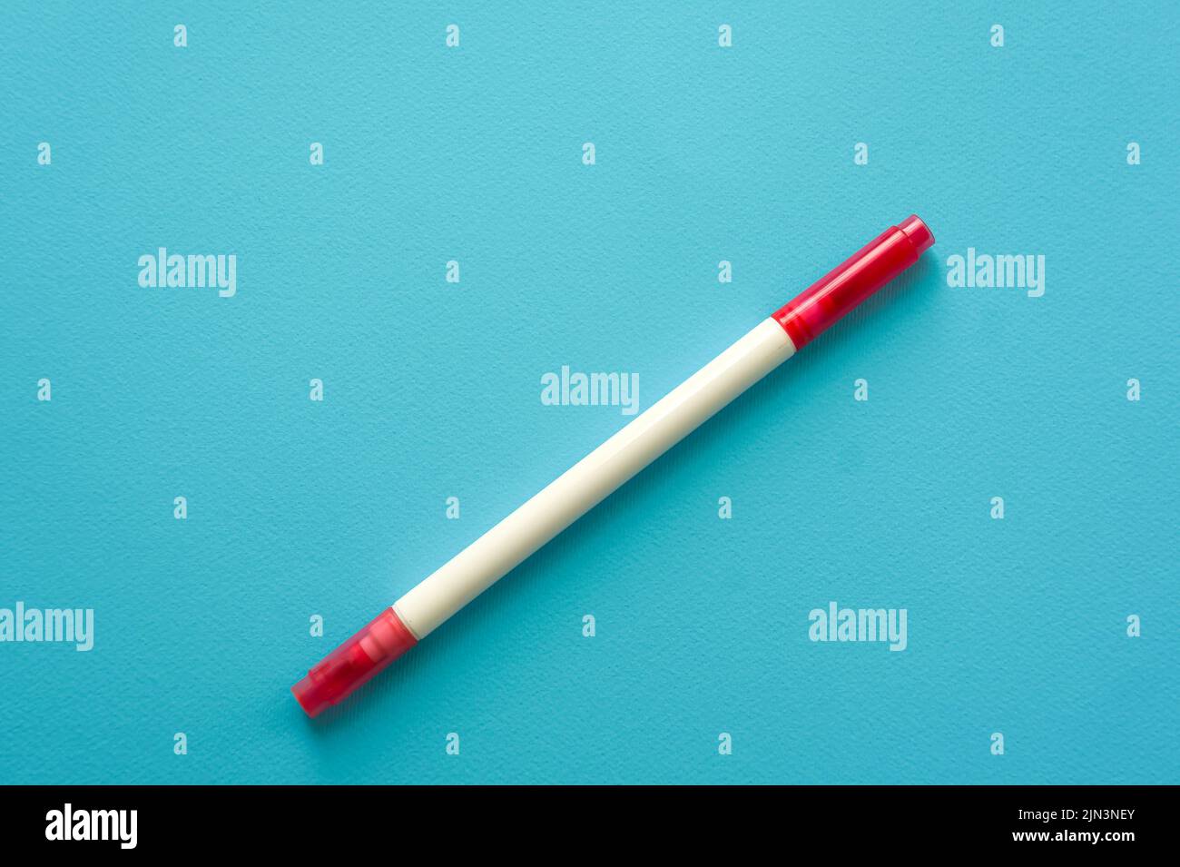 The creative concept of creativity is empty. A single red marker for marking lie off the edge of the blue kraft background. Back to school. Medical No Stock Photo