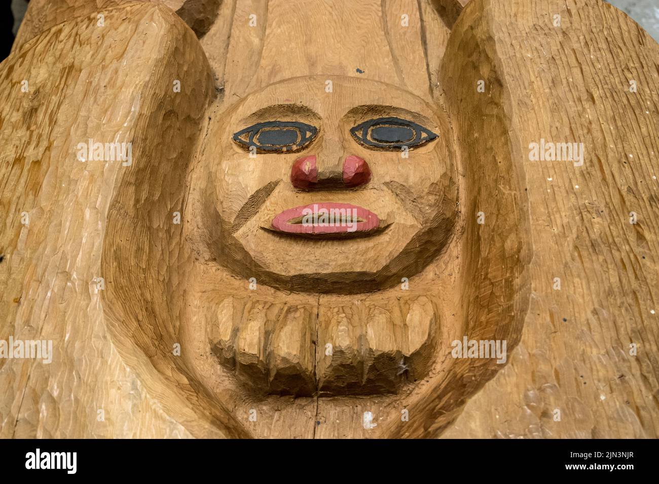 Ketchikan, AK - 10 June 2022: New carving of a face on a Totem pole in Potlatch Park in Alaska Stock Photo