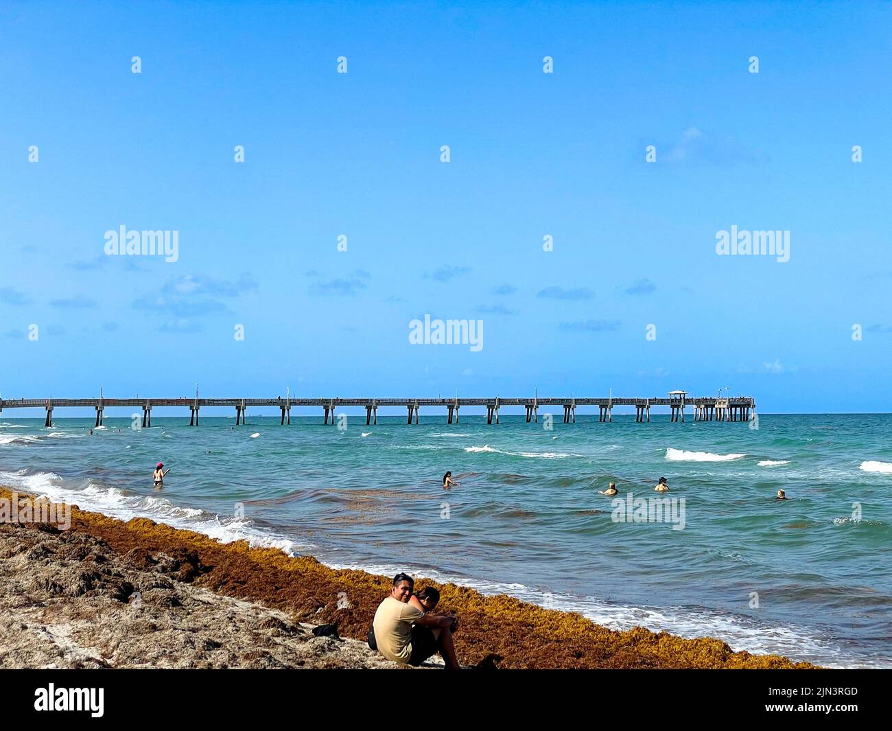 Dania Beach, FL USA July 27, 2022 Landscape view of Dania Beach Ocean Park Pier and swimmers