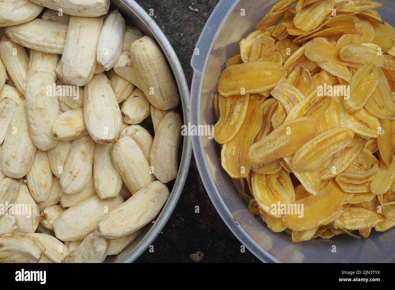 Banana chips or fried bananas before frying and after frying Stock