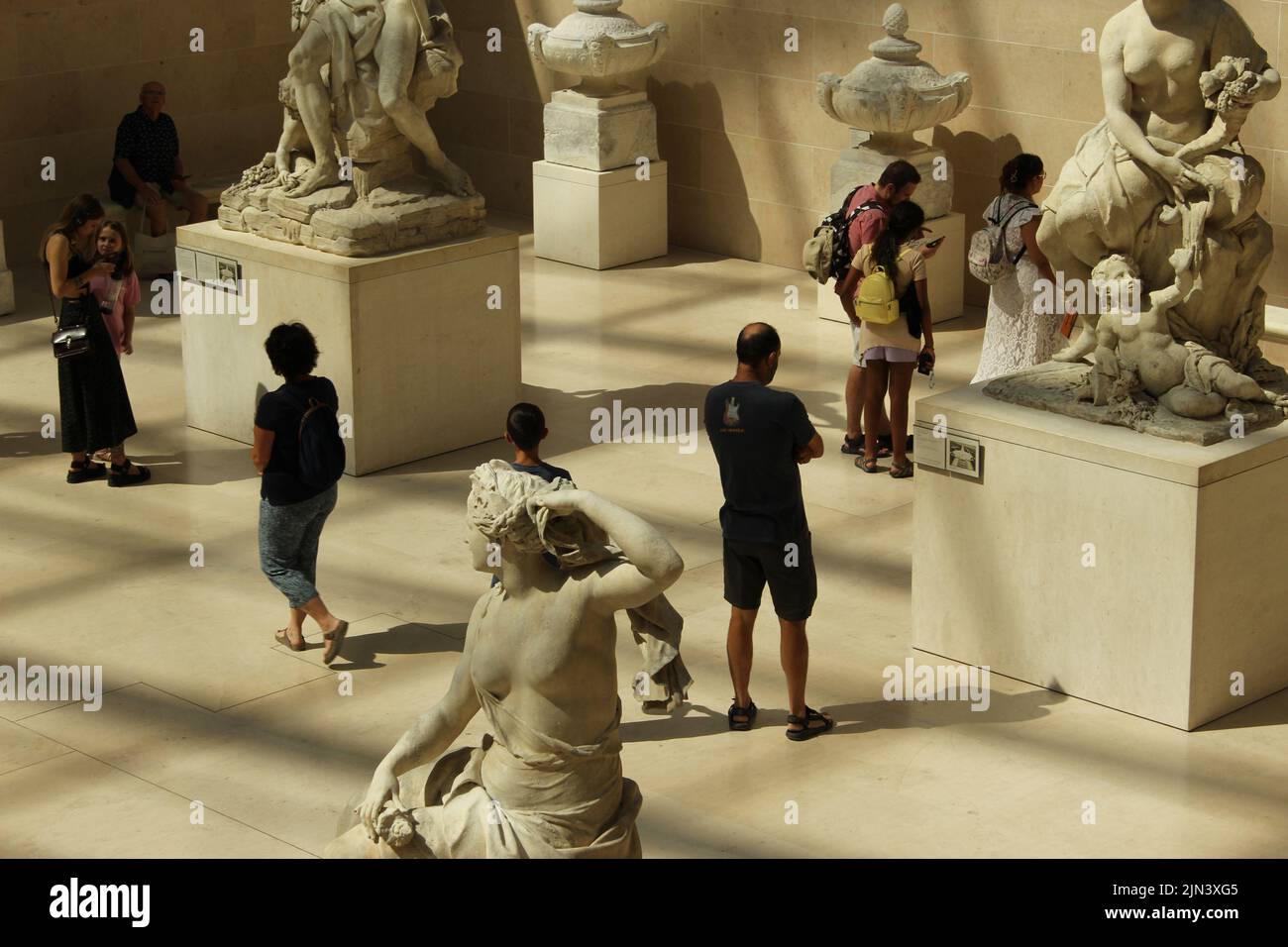 Paris, France. 8th Aug, 2022.Tourists enjoying a moment of calm among the statues in the Richelieu wing of the Louvre. Credit: Aldercy Carling/ Alamy Live News Stock Photo