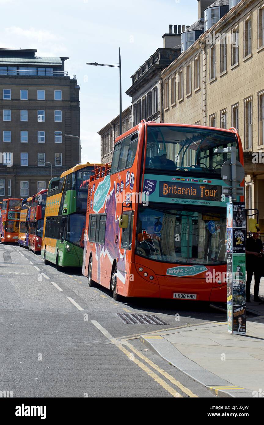 EDINBURGH, SCOTLAND - 1 AUGUST 2022: buses queue in St Andrew Square waiting for passengers for their guided tours of the city Stock Photo