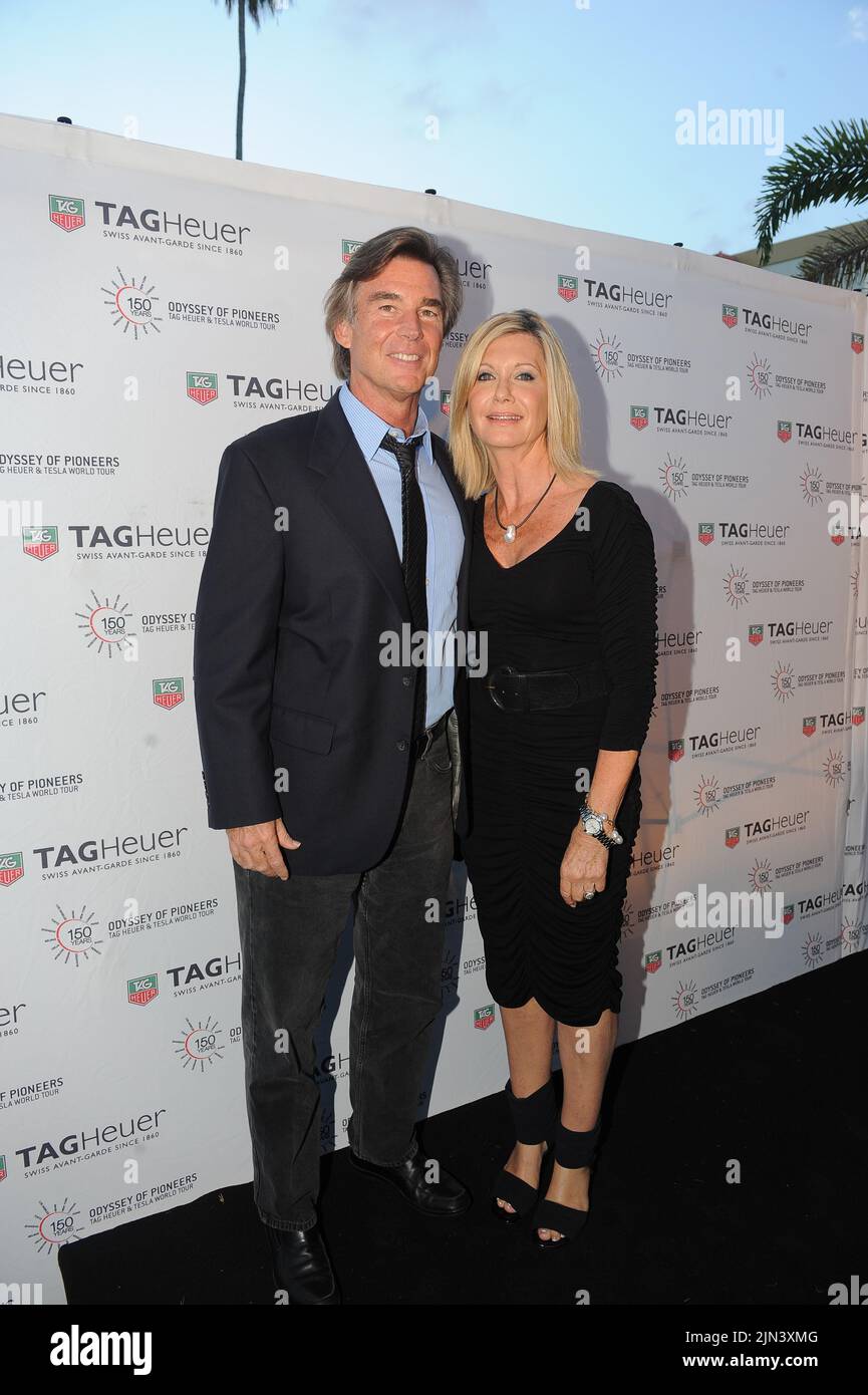 MIAMI BEACH, FL - AUGUST 19: Olivia Newton-John and husband John Easterling at the Tag Heuer watch event. Olivia Newton-John (born 26 September 1948) is an English-born, Australian-raised singer and actress. She is a four-time Grammy award winner who has amassed five No. 1 and ten other Top Ten Billboard Hot 100 singles and two No. 1 Billboard 200 solo albums. She has sold over 100 millions records worldwide making her one of the most successful female recording artists of all time. on August 19, 2010 in New York City. People: Olivia Newton-John_John Easterling Stock Photo