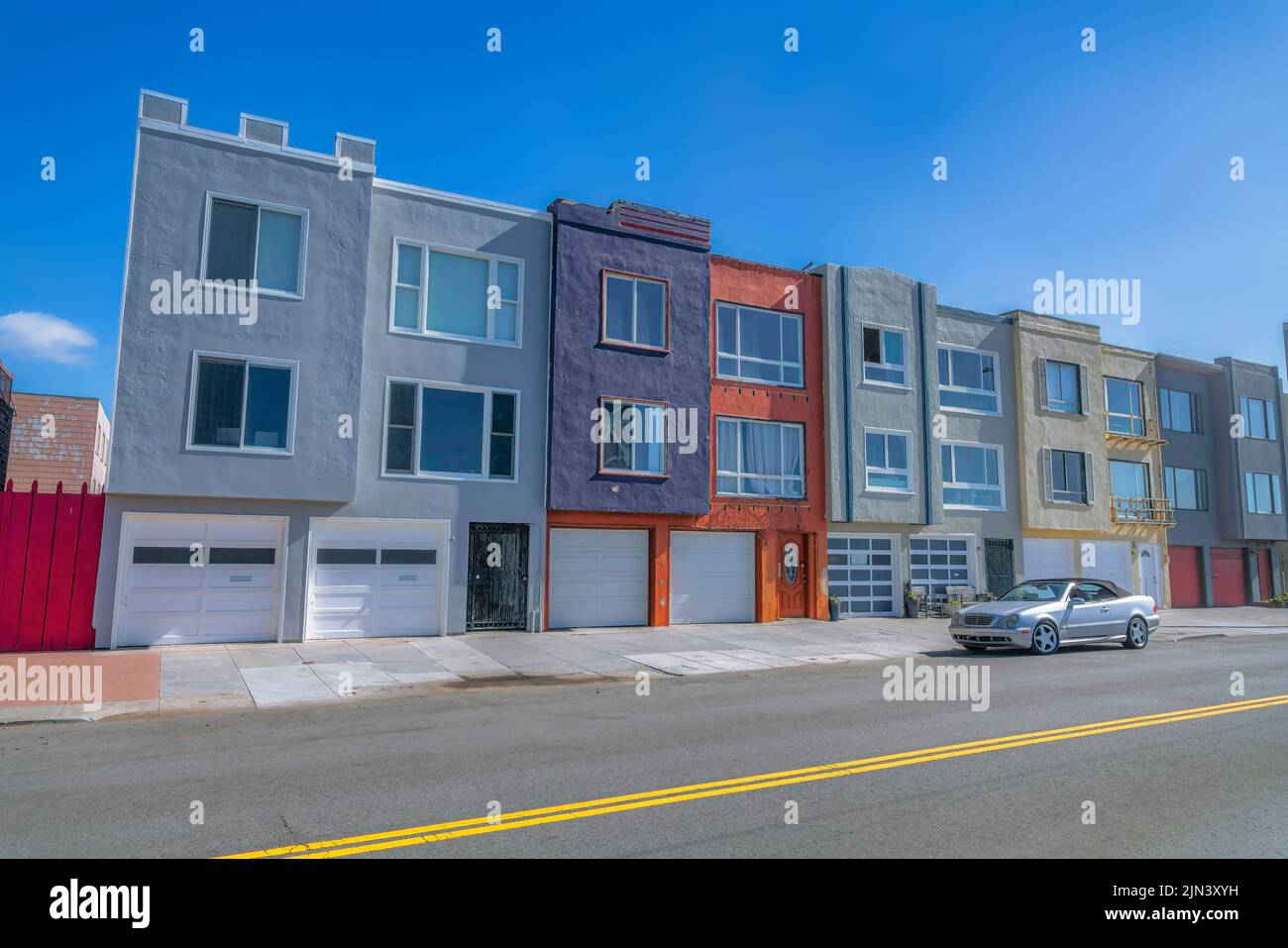 Townhouses with attached twocar garages beside the road in San