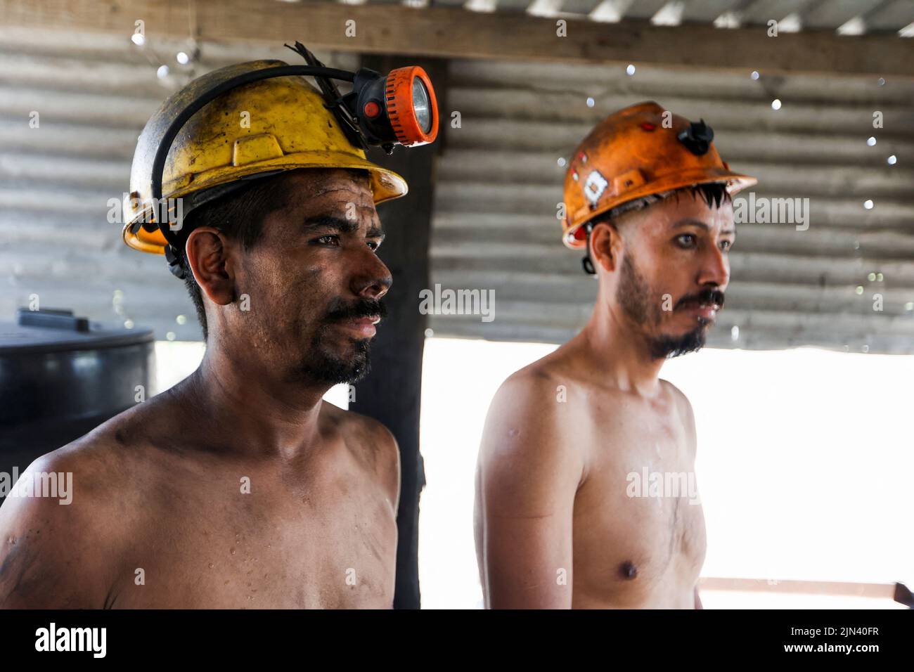 Miners work at an artisanal coal mine, or 'pocito' (little hole), known for their rudimentary and often dangerous mining techniques, in Sabinas, Coahuila state, Mexico, August 8, 2022. REUTERS/Luis Cortes Stock Photo