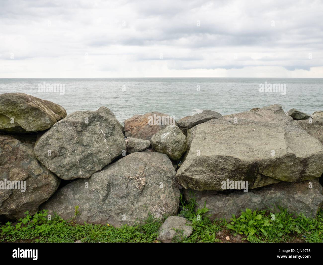 Barrier of large stones on the seashore. Wave protection. Irregular ...