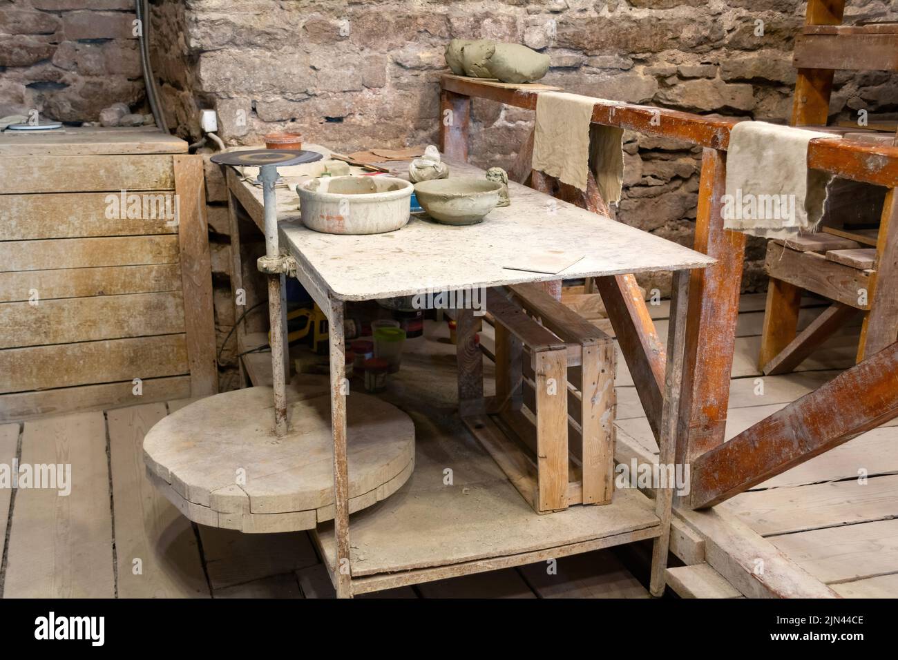 Potter's A working table with clay and a potter's wheel Stock