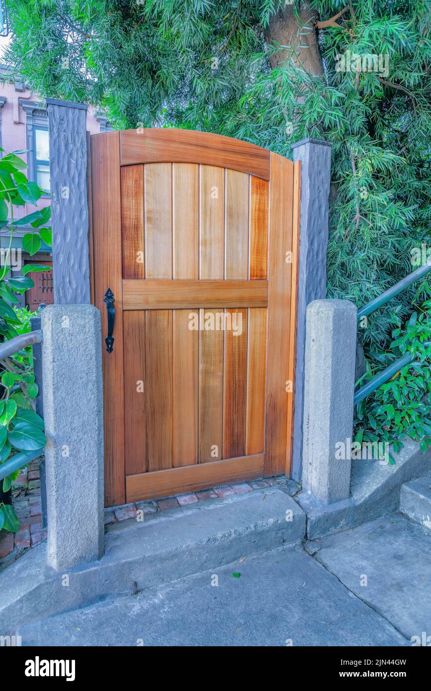 Arched wooden gate with concrete pillars in San Francisco, California