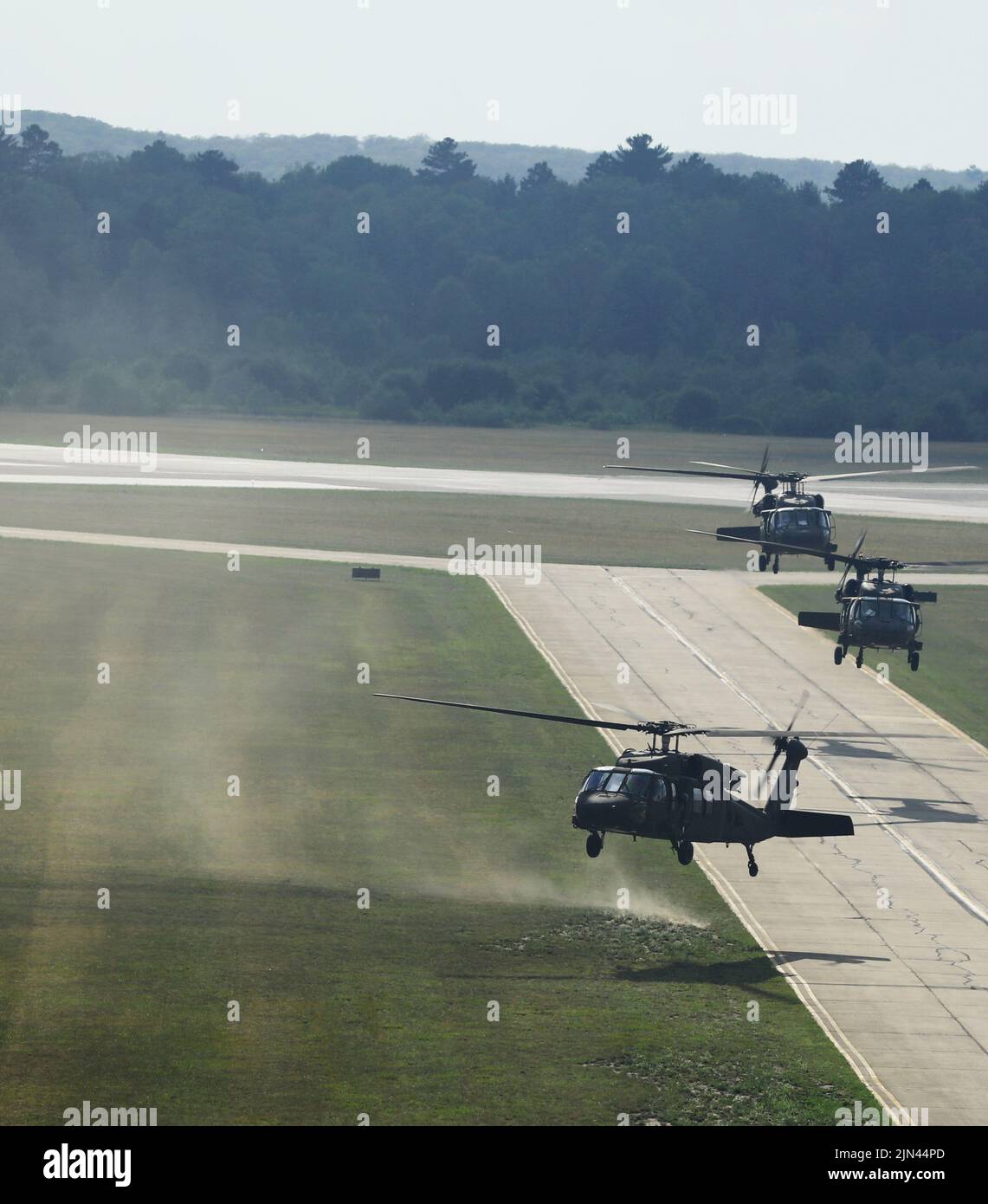 Three U.S. Army UH-60 Black Hawks land at the Grayling Army Airfield, Mich., during Northern Strike 22-2, Aug. 6, 2022. This year’s exercise brings 7,400 people from 19 states and 4 coalition countries to Northern Michigan. (U.S. Army National Guard photo by Staff Sgt. Tegan Kucera) Stock Photo