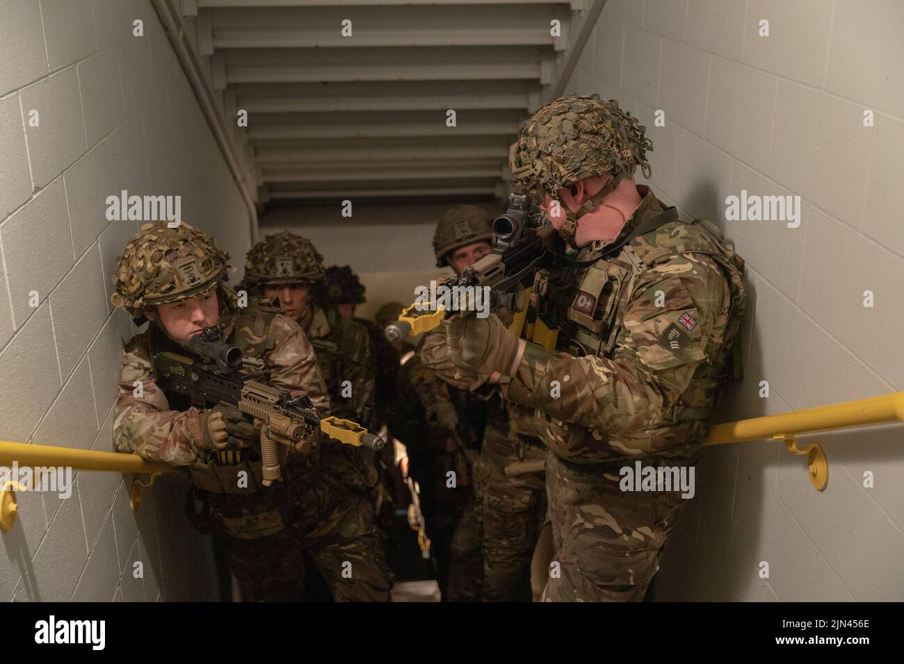 British Army Soldiers assigned to 7 Rifles, United Kingdom, begin clearing a stairwell during an Urban Assault Course training during Northern Strike 22-2, at Camp Grayling, Mich., Aug. 8, 2022. Northern Strike is designed to challenge 7,400 service members with multiple forms of training that advance interoperability across multicomponent, multinational and interagency partners. Stock Photo