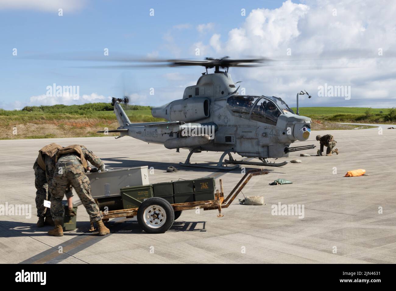 U.S. Marines with Marine Medium Tiltrotor Squadron 262 (Rein.), 31st Marine Expeditionary Unit, prepare to load ordnance into an AH-1W Super Cobra during a forward arming and refueling point exercise on Ie Shima, Okinawa, Japan, Aug. 04, 2022 A FARP is a point of operation used for fueling and rearming an aircraft outside of a forward operating base. The 31st MEU is operating aboard ships of the Tripoli Amphibious Ready Group in the 7th Fleet area of operations to enhance interoperability with allies and partners and serve as a ready response force to defend peace and stability in the Indo-Pac Stock Photo