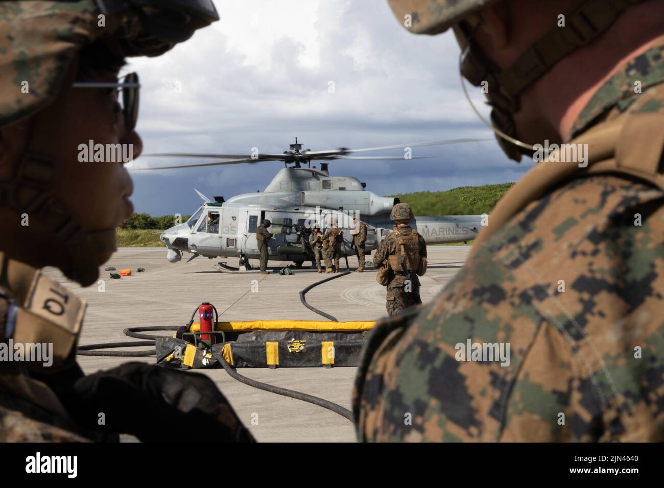 U.S. Marines with Marine Medium Tiltrotor Squadron 262 (Rein.), 31st Marine Expeditionary Unit, refuel an AH-1W Super Cobra during a forward arming and refueling point exercise on Ie Shima, Okinawa, Japan, Aug. 04, 2022. A FARP is a point of operation used for fueling and rearming an aircraft outside of a forward operating base. The 31st MEU is operating aboard ships of the Tripoli Amphibious Ready Group in the 7th Fleet area of operations to enhance interoperability with allies and partners and serve as a ready response force to defend peace and stability in the Indo-Pacific region. (U.S. Mar Stock Photo