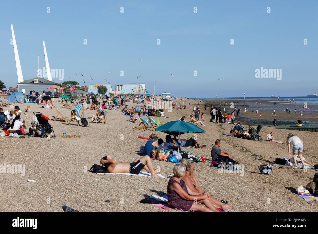 An English Beach with tourists enjoying the sunny weather during the heatwave of 2022 Stock Photo