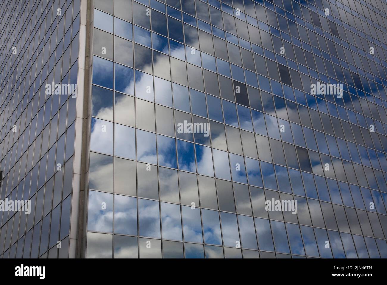 Blue sky and clouds reflected in modern glass and steel office tower, Montreal, Quebec, Canada Stock Photo