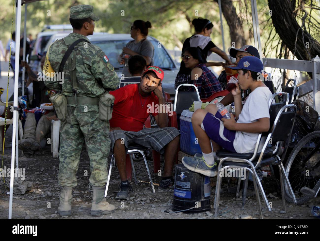 Relatives of miners wait for news about their loved ones outside the facilities of a coal mine where a mine shaft collapsed leaving miners trapped, in Sabinas, Coahuila state, Mexico, August 7, 2022. REUTERS/Luis Cortes Stock Photo