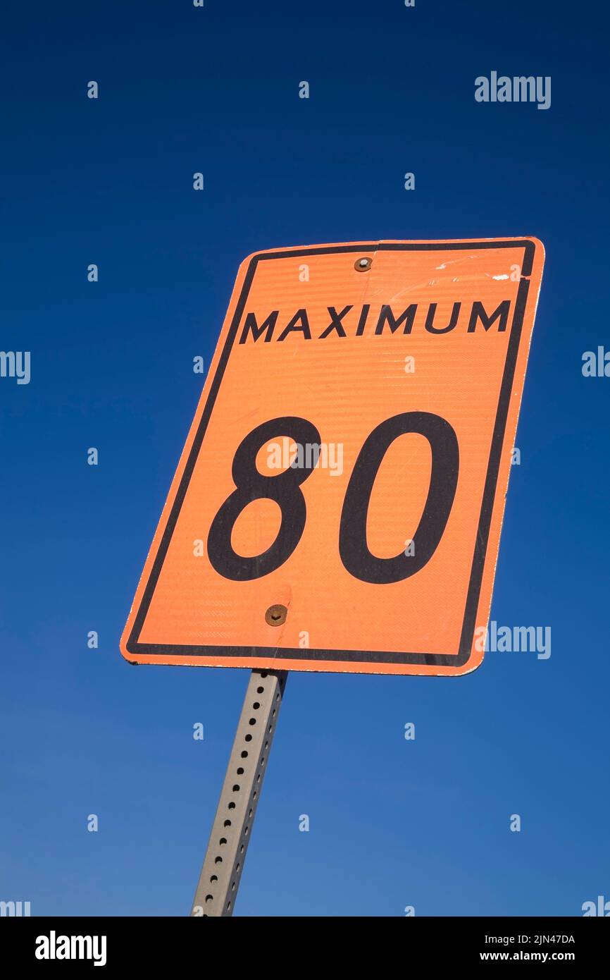 Orange 80 maximum speed limit traffic sign against a blue sky background, Quebec, Canada Stock Photo