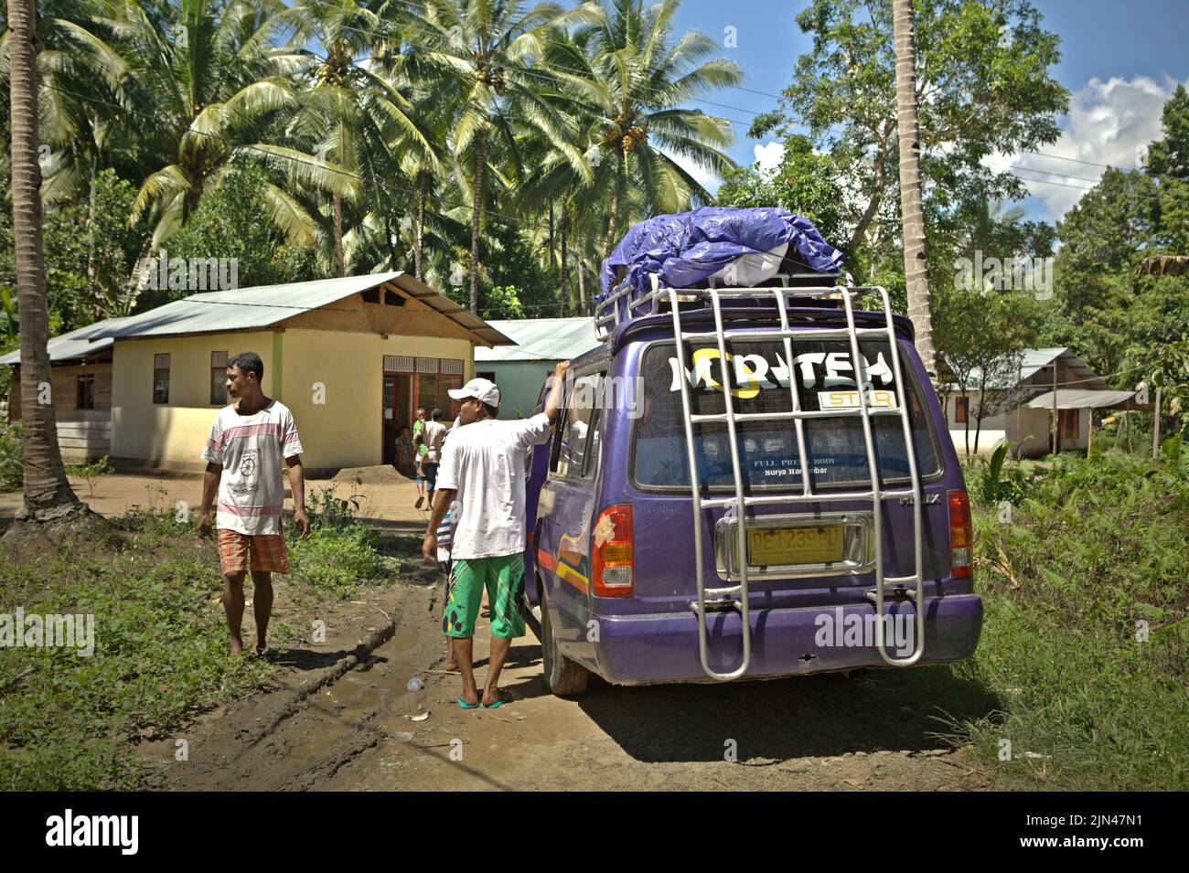 A hired minibus for tourism is about to leave Horale village in Seram Utara Barat, Maluku Tengah, Maluku, Indonesia. Stock Photo