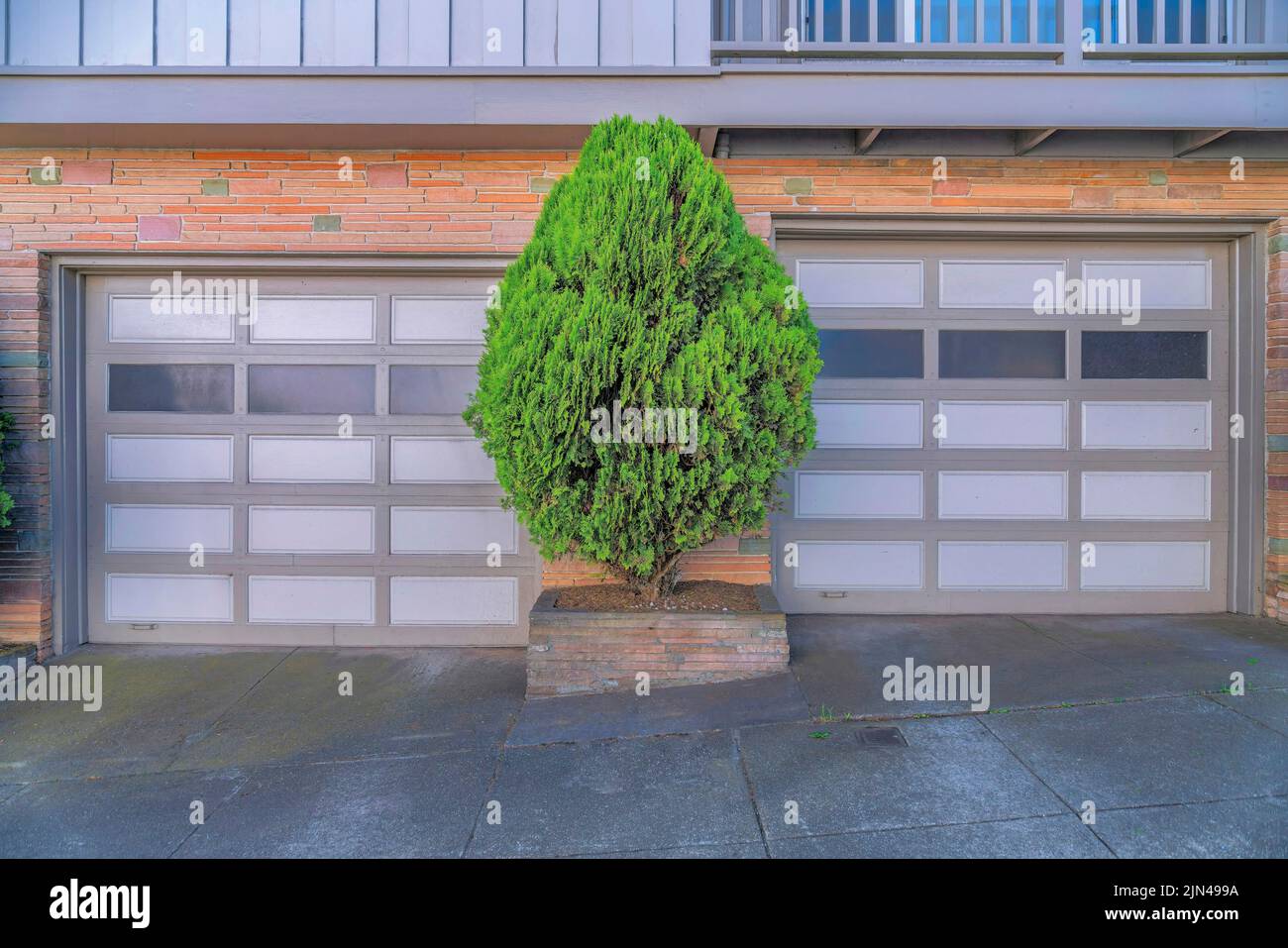 Two garage doors with small tree in between at San Francisco, California. Attached garage ...