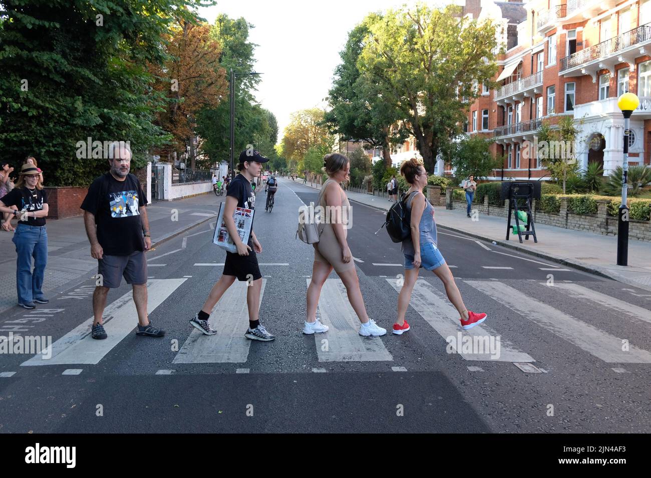 London, UK, 8th Aug, 2022. Beatles fans pose for photos on the crossing used by the band 53 years ago to the day that was used on a photographic shoot for the 'Abbey Road' album cover. On the morning of 8th August 1969 Photographer Iain Macmillan took just six shots of the group walking across the zebra crossing that is close to the recording studio. Credit: Eleventh Hour Photography/Alamy Live News Stock Photo