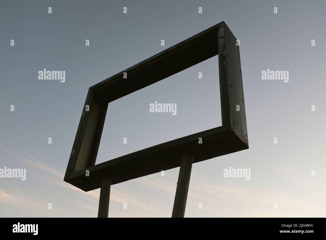 Low Angle View of Old Metal Sign Frame with No Message against dusky Sky Stock Photo