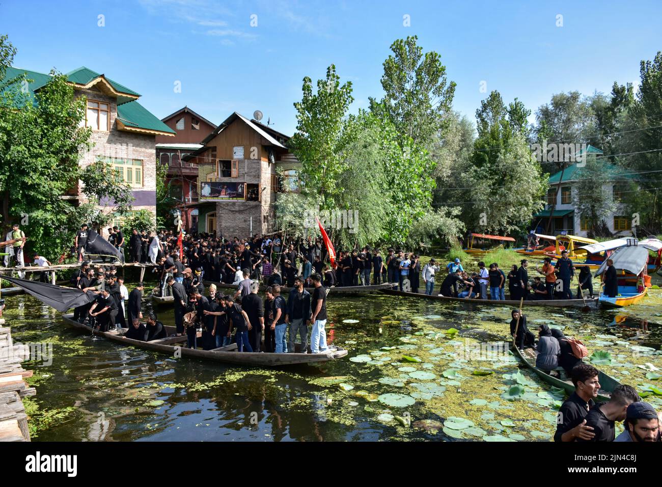 Kashmiri Shiite Muslims shout religious slogans as they ride on boats ...