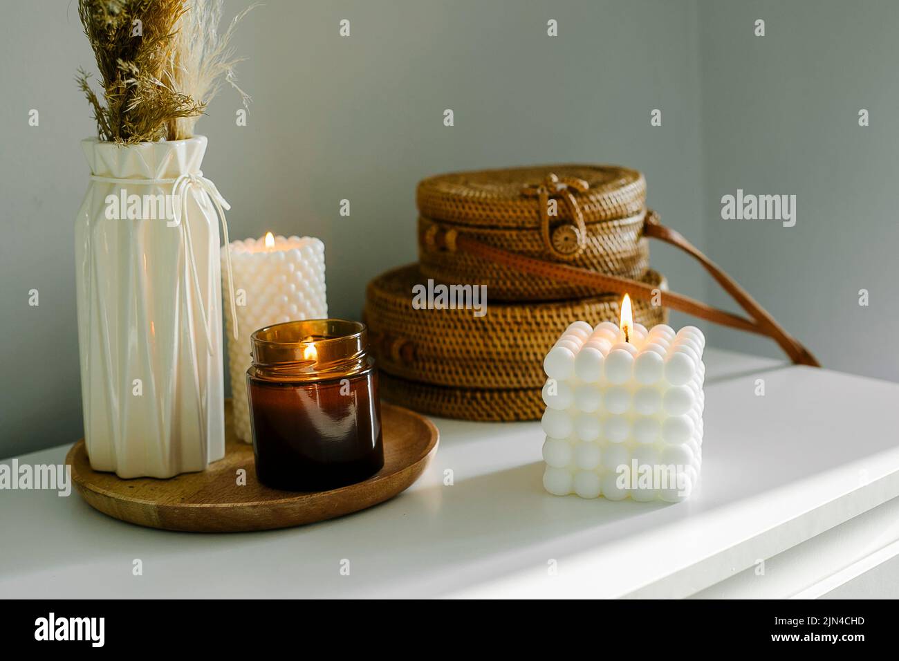Elegant home decoration with wooden wick burning candle in brown glass ...
