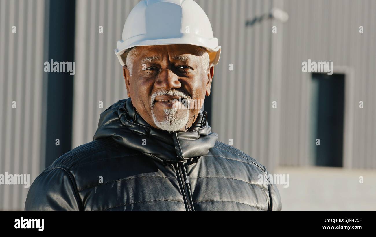 Portrait of elderly african american confident man professional engineer construction worker in safety helmet successful builder contractor foreman Stock Photo