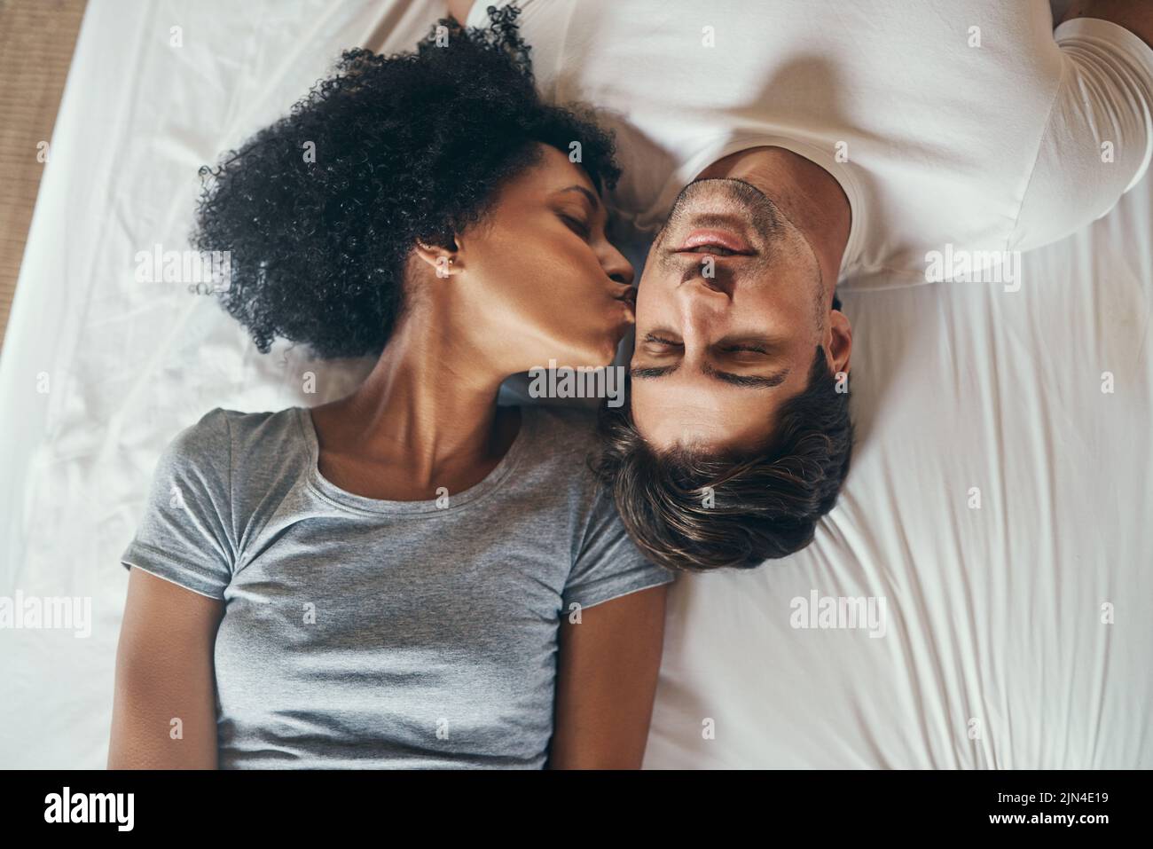 Romantic couple kissing in bed hi-res stock photography and images - Alamy