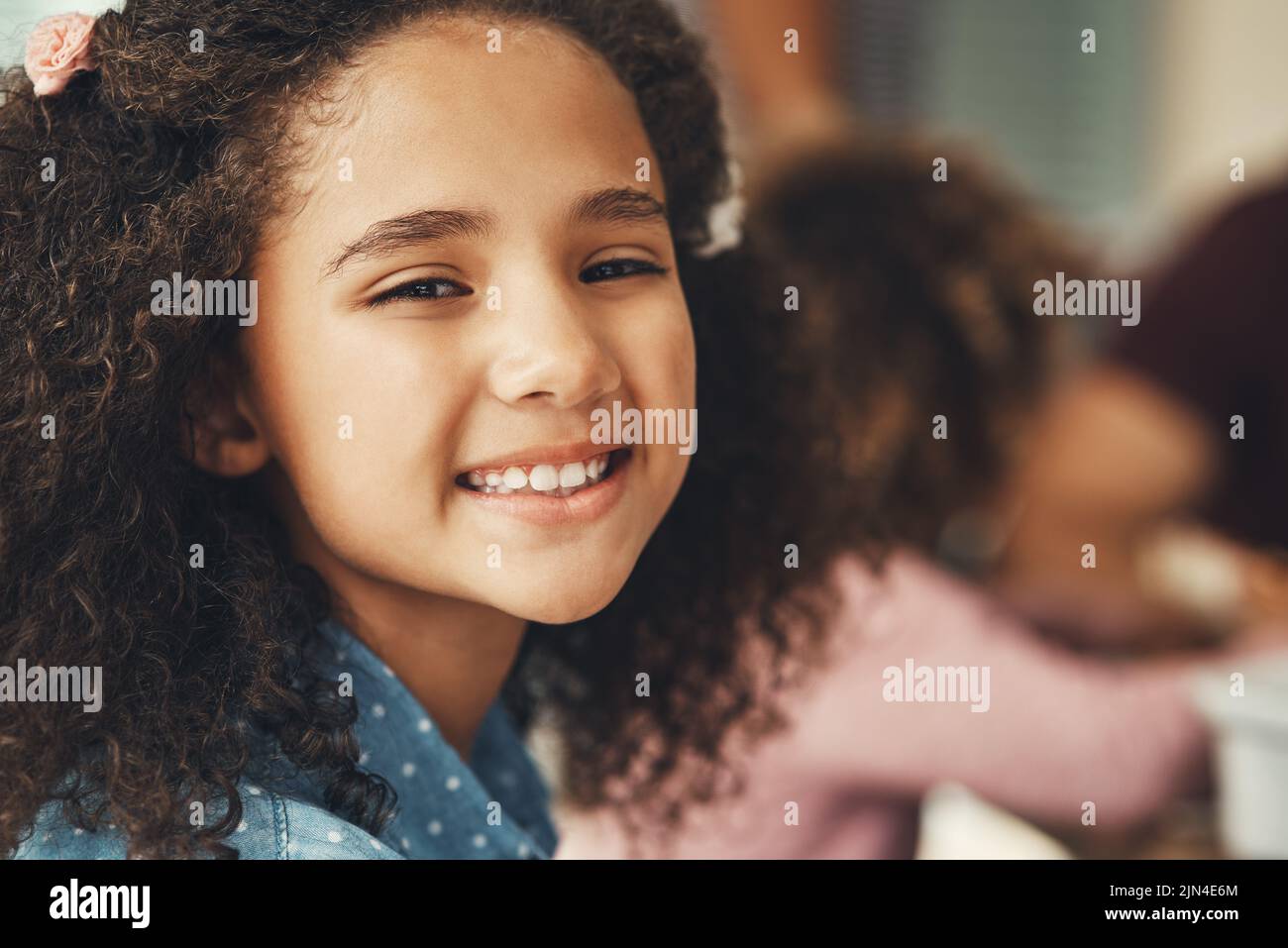 Im always happy when we all get together. Portrait of an adorable little girl enjoying herself during a family gathering. Stock Photo
