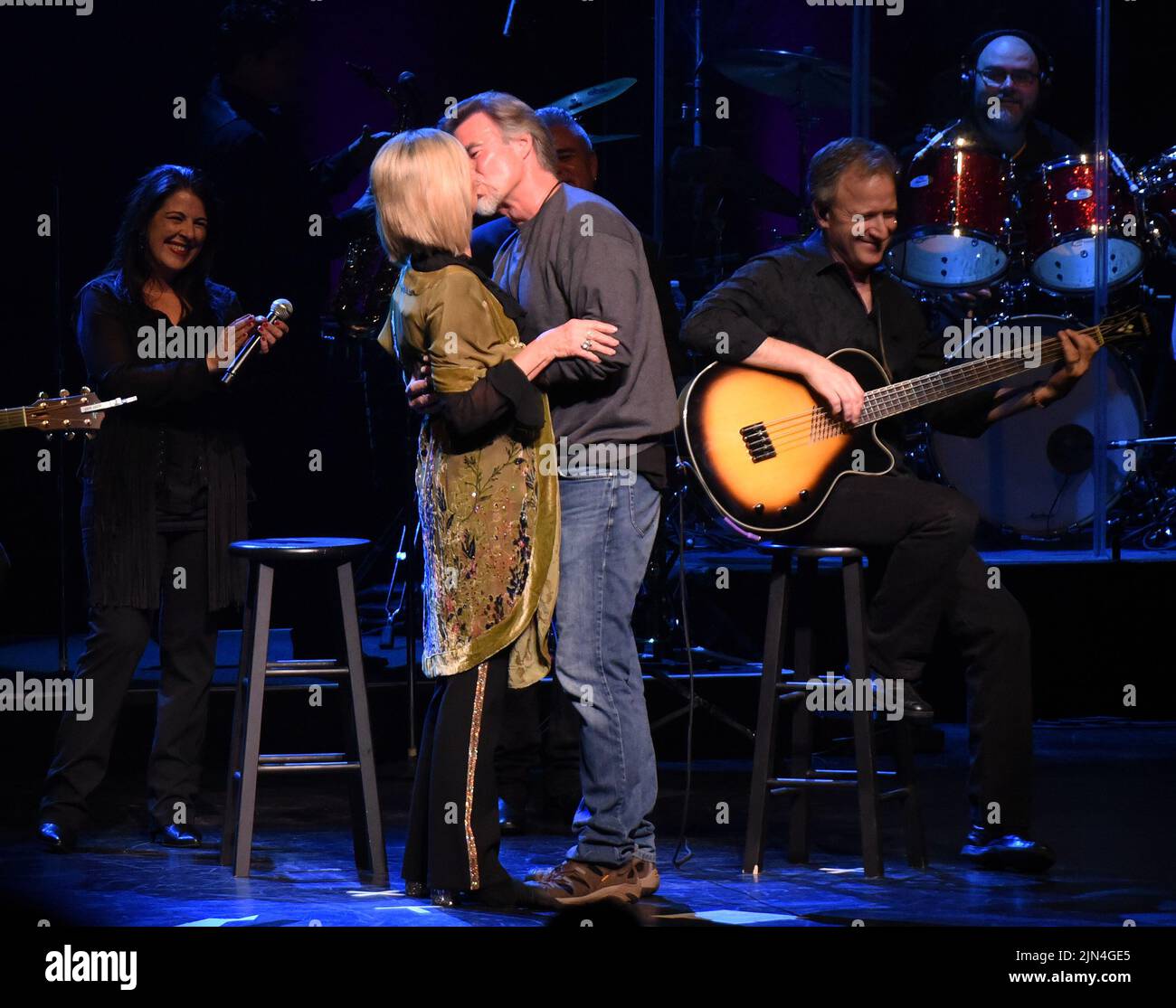 ATLANTA, GA - April 9, 2017: Olivia Newton-John surprises her husband John Easterling by singing a parody of “The Girl From Ipanema” as “The Boy From North Carolina” (in his honor) which she had sung for him at their wedding. The surprise performance took place at Cobb Energy Center in Atlanta, Georgia on April 9, 2017. CREDIT: Chris McKay / MediaPunch Stock Photo