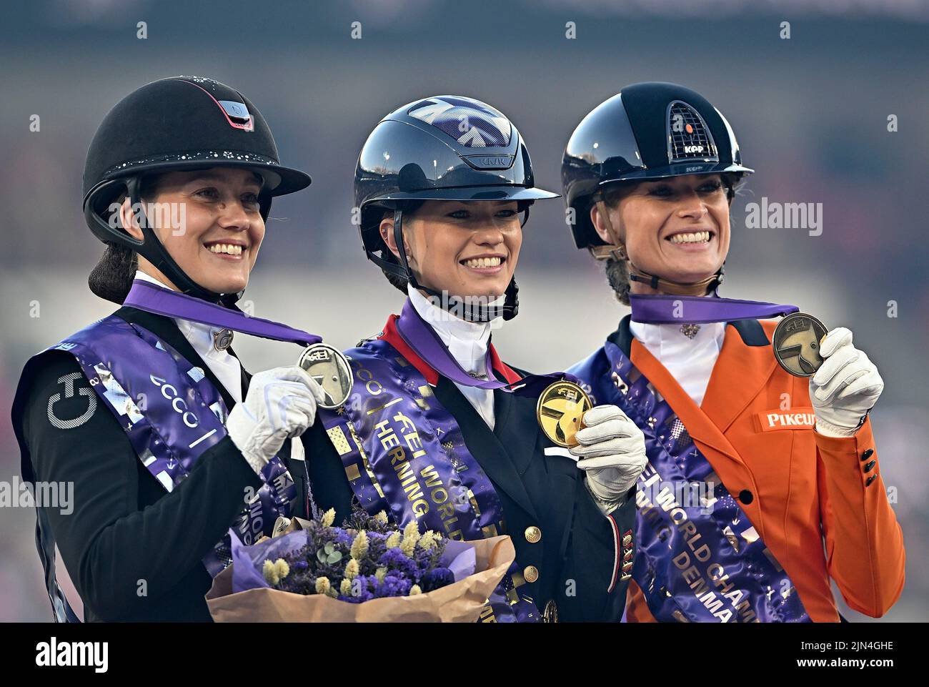 Herning, Denmark. 08th Aug, 2022. World Equestrian Games. The three medalists of the Blue Hors FEI world dressage grand prix special championship. (l to r) Cathrine Laudrup-dufour (DEN, silver) riding VAMOS AMIGOS, Charlotte Fry (GBR, gold) riding GLAMOURDALE and Dinja Van Liere (NED, bronze) riding HERMES Credit: Sport In Pictures/Alamy Live News Stock Photo