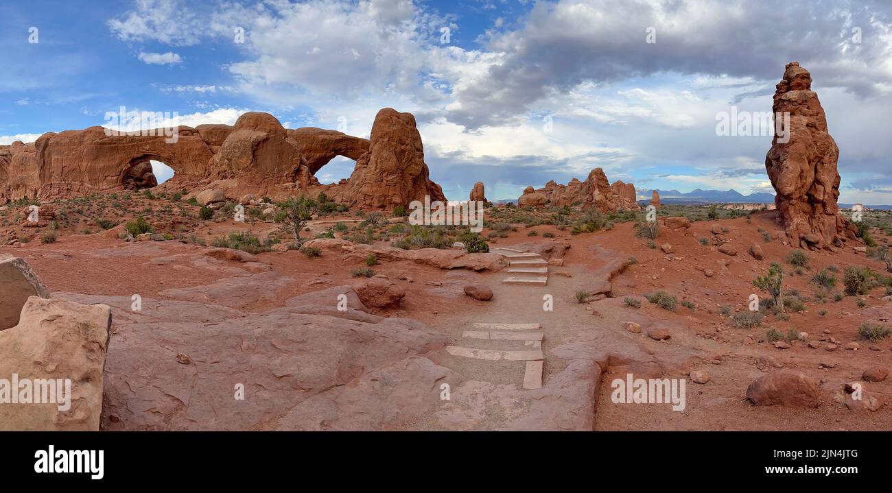 Panoramic view of the Windows area in Arches National Park with mountains on the background, Utah Stock Photo