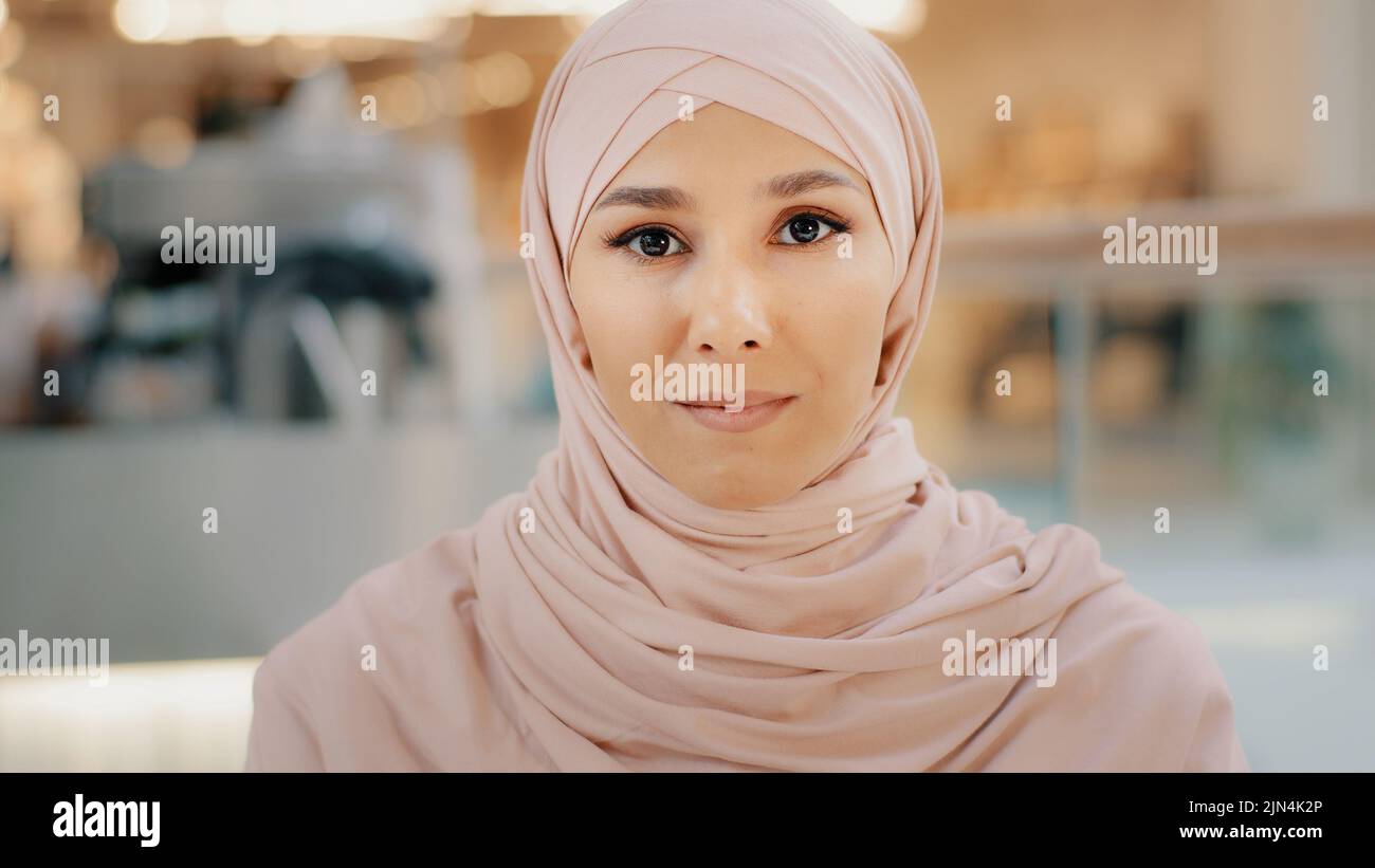 Webcam view young arab muslim woman in hijab speaks looking at camera smiling girl talking on cam job interview female entrepreneur explaining terms Stock Photo