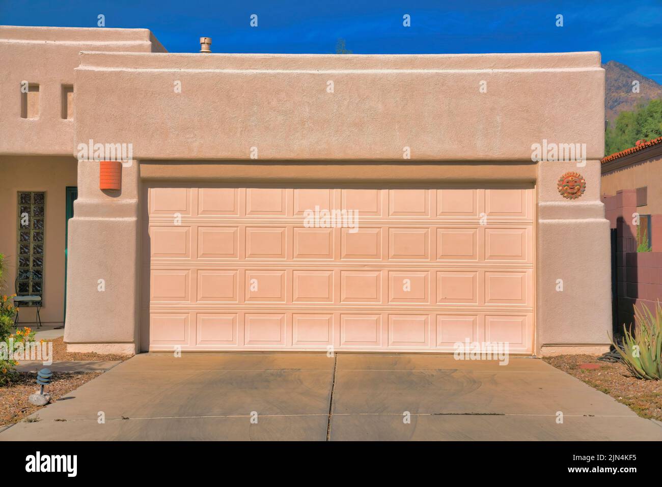 Garage exterior of a painted cream mediterranean home at Tucson